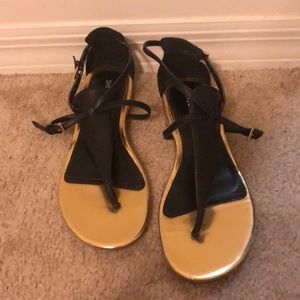 Metallic gold and black sandals